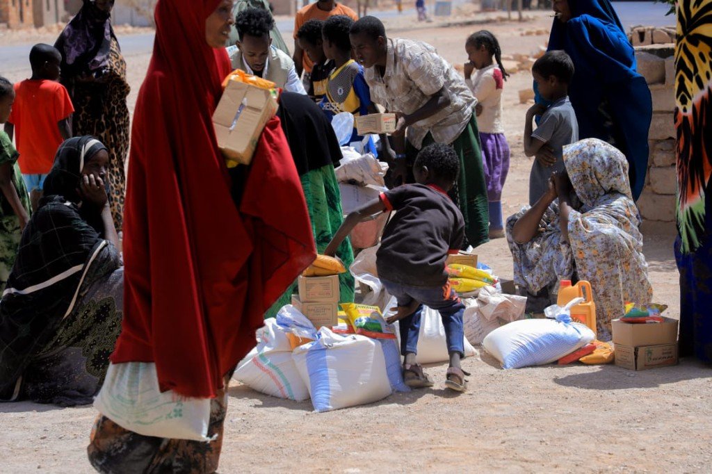 Families collecting essential food packages and cooking oil